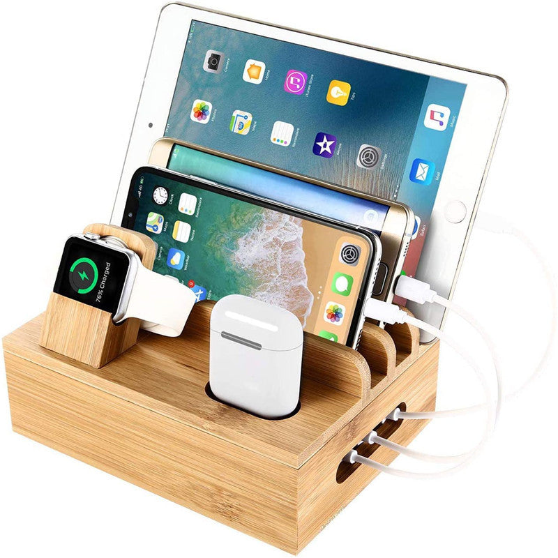 Wooden charging station with multiple electronic devices on a white background