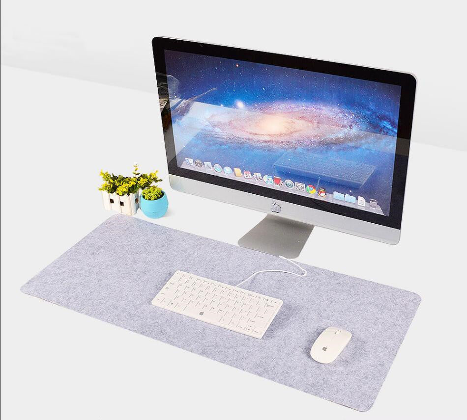 Ash desk mat with white keyboard and mouse on a modern computer workstation