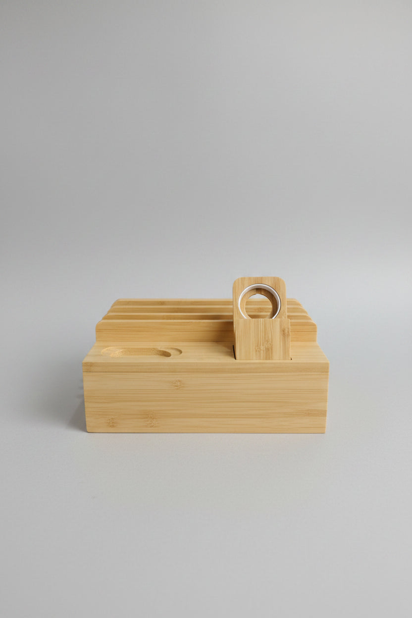 A light natural bamboo ring stand with multiple vertical slots and a hinged lid, shown on a blue-and-white checkered desk mat with a red basket in the background.